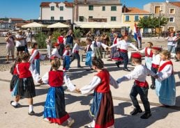 Tourists enjoy old traditions in Croatian fishing village of Betina